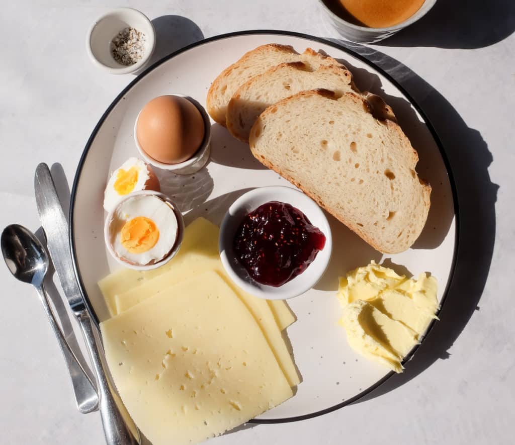 Danish Breakfast Plate with Havarti cheese, boiled eggs, sweet jam, whipped butter, and slices of Sourdough Vienna – a delicious and simple Kiwi breakfast.